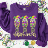 It's Mardi Gras Y'all Nutcrackers DTF Heat Transfer, purple sweatshirt with colorful nutcracker design and Mardi Gras themed text.