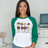 Just A Mardi Goose DTF Heat Transfer, a woman wearing a white and green long sleeve shirt with colorful duck characters and the text 'just a mardi goose' on the front.