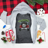 Christmas Jeep Youth Screen Print Heat Transfer, a graphic of a car with a Christmas tree on top and 'Merry Christmas' message, on a dark grey T-shirt, surrounded by holiday decorations and clothing.