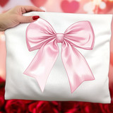 Pink Coquette Bow DTF Heat Transfer, pink satin bow design on a white pillow with a hand holding the pillow, romantic blurred pink background.