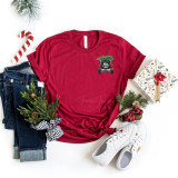 Christmas Jeep HAT/POCKET Screen Print Heat Transfer, red t-shirt with a Jeep truck design and Christmas greenery, surrounded by jeans, sneakers, Christmas gift box, candy cane, pine branches, and holiday decorations.
