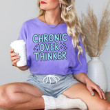 Retro Chronic Overthinker DTF Heat Transfer, woman wearing purple sweatshirt with 'Chronic Over Thinker' graphic, holding coffee cup, casual indoor setting.