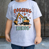 Diggin' XOXOs DTF Heat Transfer, colorful graphic of a construction excavator with hearts and the words 'Diggin' XOXOs' on a child's gray T-shirt.