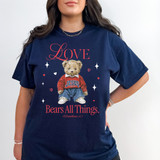 Love Bears All Things RED DTF Heat Transfer, graphic design on a navy T-shirt featuring a teddy bear with religious text and decorative hearts and stars.
