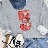 Basketball Number Sequin Patch, a red and black sequin patch of the number five applied on a gray sweatshirt.