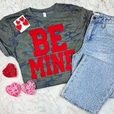 Be Mine fluffy letter patch with raised red texture on a camo Valentine-themed graphic t-shirt