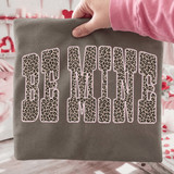 Leopard Be Mine DTF Heat Transfer, leopard print heart-shaped text sticker on grey fabric.