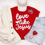 Love Like Jesus Fluffy Valentine's Day Patch - 3 colors, featuring a close-up of the patch on a red t-shirt with white text, paired with a cream cardigan, distressed denim shorts, pink and red heart-shaped decorations, and pink love-themed earrings.
