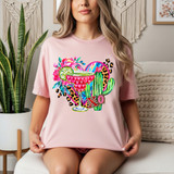 Patterned Margarita Collage DTF Heat Transfer, colorful tiki-inspired beverage design with floral, cactus, and vibrant patterns on a pink t-shirt worn by a woman.
