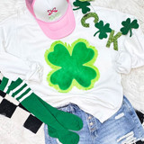 Velvet Shamrock Fringe Patch, a green velvet shamrock patch with a fringed border placed on a white shirt.