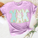 Cottagecore Bunny Trio DTF Heat Transfer, pastel pink t-shirt with three cute bunny silhouettes in different floral and polka dot patterns with flower accents, designed for crafting and apparel customization.