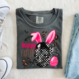 Hoppy Easter Skull DTF Heat Transfer, a t-shirt design featuring a skull with bunny ears, decorated with pink and black checkered patterns, surrounded by butterflies and Easter eggs.