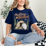 Rolling Stones Tomb DTF Heat Transfer, detailed graphic design of a cave entrance with rocks, trees, and a waterfall on a navy blue T-shirt.