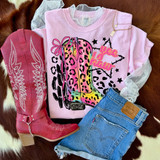 Yee Haw Leopard Bow DTF Heat Transfer, colorful leopard print cowboy boot design on pink t-shirt with pink bow, denim shorts, and pink cowboy boots.