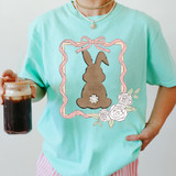 Bow Framed Bunny DTF Heat Transfer, product image showing a cute bunny design within a pink bow-shaped frame, on a pastel green T-shirt.