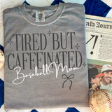 Tired But Caffeinated Baseball Mom BLACK DTF Heat Transfer T-shirt with printed text and design.