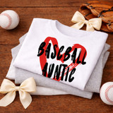 Baseball Heart Title DTF Heat Transfer, white t-shirt with a red heart and bold black text reading 'Baseball Lover', displayed on a wooden surface with baseballs, gloves, and cream-colored bows.