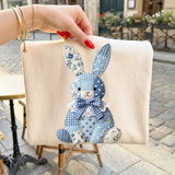 Faux Fabric Patchwork Blue Cottagecore Bunny DTF Heat Transfer, fabric patchwork bunny design with blue floral and polka dot patterns, mounted on a light-colored textile background.