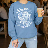 Houston We're Ready For Testing WHITE DTF Heat Transfer, close-up of a person wearing a blue sweatshirt with space-themed astronaut graphic design.