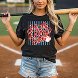 Hit The Dang Ball Script DTF Heat Transfer, a baseball-themed graphic design on a black t-shirt worn by a woman holding a baseball bat on a baseball field.