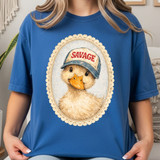 Savage Duck DTF Heat Transfer, cute duck graphic wearing a cap on a blue t-shirt.