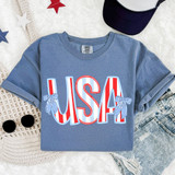 Striped USA Bow DTF Heat Transfer, colorful USA-themed design with bows on the letters, printed on a casual blue T-shirt.