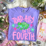 Toad-Ally On To Pink DTF Heat Transfer, colorful T-shirt with a green frog graphic and pink text on a purple background.