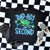 Toad-Ally On To Blue DTF Heat Transfer, colorful graphic T-shirt with a green and blue frog and stars on a black background.