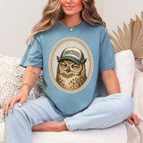 Unbothered Owl DTF Heat Transfer, a woman wearing a blue T-shirt with an owl wearing a cap that says 'Unbothered' in a decorative oval frame.