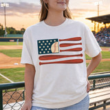 USA Baseball Bats DTF Heat Transfer, design of the American flag with baseball bats on a woman's white t-shirt at a baseball stadium.