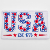 Floral USA Embroidered Hat Patch – “EST. 1776” Patriotic Boutique Patch with red flowers and blue embroidery on a white background.