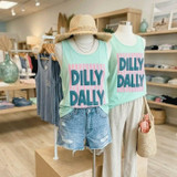 Dilly Dally Stripes Puff Screen Print Transfer, pastel mint sleeveless top with bold blue and pink logo design displayed on a mannequin and a stand in a clothing store.