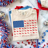 Paws & Stripes Forever DTF Heat Transfer, patriotic-themed T-shirt with red, white, and blue dog and paw print design, American flag style pattern, and festive decorations around it.