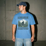 Dad Like Me Is Hard To Find DTF Heat Transfer, image of a man wearing a blue T-shirt with a graphic of a Bigfoot silhouette in a forest with mountains, and the text 'A Dad Like Me Is Hard To Find'.
