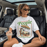 My Tolerance For People Last This Long DTF Heat Transfer, woman sitting in a car wearing a humorous graphic T-shirt with a cartoon zebra on a beach chair with an umbrella and drink.