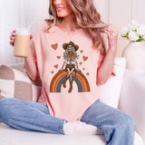 Cowgirl Skeleton Rainbow DTF Heat Transfer, colorful skeleton design on a pink T-shirt with rainbow, hearts, stars, and cowgirl hat features.