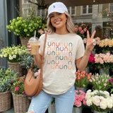 Boho Horseshoes DTF Heat Transfer, woman holding iced coffee and making a peace sign in front of a colorful flower shop