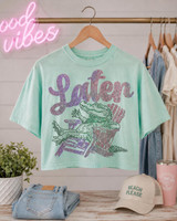 Lator Gator Spangle Heat Transfer, mint green T-shirt with colorful rhinestone design of a crocodile eating fries and the word 'Laton' on it.