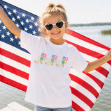 Patriotic Ducks DTF Heat Transfer, a smiling girl wearing heart-shaped sunglasses and a patriotic-themed t-shirt, holding an American flag and standing by the water with a patriotic-themed decoration.