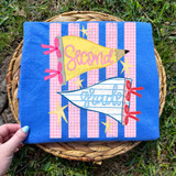 Grade School Pennant DTF Heat Transfer, colorful school themed pennants with 'Second' and 'Grade' text, pink and blue checkered flag designs, on a blue fabric background with star decorations.