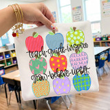Teach Guide Inspire Grow Believe Uplift DTF Heat Transfer, colorful apple design on a white tote bag in a classroom setting.