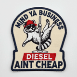 Mind Ya Business, Diesel Ain't Cheap Hat Patch – 2.5 x 3 inches, embroidered patch featuring a cat with a red hat holding a pole, with text "DIESEL" and "AINT CHEAP" on the patch.
