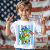 Patriotic Snapback Gator DTF Heat Transfer, a boy wearing a t-shirt with a cartoon alligator holding an American flag, in front of a blurred American flag background.
