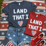 Land That I Love fluffy patch with soft raised white lettering and patriotic American flag heart detail, lightweight textured iron-on patch for patriotic apparel, Fourth of July shirts, Americana sweatshirts, and boutique clothing collections.Soft texture. Patriotic charm. Boutique bestseller potential. ❤️  This Land That I Love Fluffy Patch combines dimensional raised lettering with a patriotic heart accent to create a design that instantly adds depth, texture, and visual interest to any garment.  The fluffy finish gives apparel that premium boutique look customers love while remaining lightweight and comfortable. Unlike heavy embroidery or bulky appliqués, this patch creates a soft-touch textured effect that adds dimension without weighing down the garment.  Featuring oversized fuzzy lettering paired with a stars-and-stripes heart, this design captures everything shoppers love about Americana style. It's perfect for patriotic collections, summer launches, holiday drops, and year-round American-inspired apparel.  Give your customers something they can actually feel.  This textured patch transforms ordinary sweatshirts, tees, and pullovers into elevated boutique pieces with minimal production time. The raised fluffy texture photographs beautifully for ecommerce listings, social media content, live sales, and product videos, making it a strong addition to apparel collections built around Memorial Day, Fourth of July, Veterans Day, summer vacations, lake weekends, concerts, and Americana fashion.  The combination of soft texture and patriotic styling creates a timeless look that returns season after season, helping apparel businesses offer premium-feeling products without complicated production methods.  Lightweight. Soft-touch. Americana approved.  Features Oversized fluffy raised lettering Patriotic American flag heart detail Soft textured finish Dimensional appearance without added bulk Lightweight construction Boutique-quality look and feel Heat press ready Easy application Premium apparel embellishment Designed for sweatshirts, tees, pullovers, and more Perfect For Patriotic apparel collections Fourth of July launches Memorial Day merchandise Veterans Day collections Americana apparel Summer fashion drops Boutique graphic apparel Live sale inventory Social media product launches Custom apparel businesses Suggested Apparel Pairings Navy crewnecks Red graphic tees White sweatshirts Chambray apparel Oversized pullovers Americana collections Summer boutique launches Patriotic holiday apparel Why Customers Love It  Customers are increasingly drawn to apparel that offers more than just a printed graphic. Textured embellishments continue to trend because they create a premium look and feel while adding visual dimension that stands out both online and in person.  The fluffy raised lettering creates a cozy, touchable finish while the patriotic heart adds a classic Americana element that works across multiple seasons and holidays. The result is a versatile design that feels festive without being limited to a single occasion.  Application Instructions Remove the protective backing sheet from the patch. Position the patch with the adhesive side facing down onto the garment. Press at 325°F for 15 seconds using medium pressure. Allow the patch to cool before checking adhesion. Repress if necessary for optimal bonding.  Always test on a sample garment before bulk production.  Mock-Up  Gildan Softstyle Navy & Red