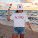 May Freedom Forever Fly DTF Heat Transfer, woman holding ice pop at the beach with sunset in background.