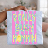 Really Busy Mommin' DTF Heat Transfer, colorful design with pink stripes and yellow text with blue outline for a comforting mom-themed craft.