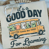 It's A Good Day For Learning School Bus DTF Heat Transfer, colorful design featuring a school bus with cute animal characters and the text 'It's a Good Day for Learning' on fabric.
