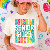 Retro Checkerboard Senior 2027 DTF Heat Transfer, colorful checkered design with stars and the text 'Senior 2027' on a white t-shirt worn by a smiling girl.