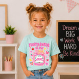 Is My Jam Back to School DTF Heat Transfer | Grades Pre-K–4, a young girl wearing a light blue t-shirt with colorful back to school design and the phrase 'Fourth Grade is My Jam' printed on it.