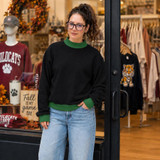 Blank Mockneck Sweatshirt — Preorder | Multiple Colors, woman wearing a black mockneck sweatshirt with green accents, casual style, in a retail clothing store.